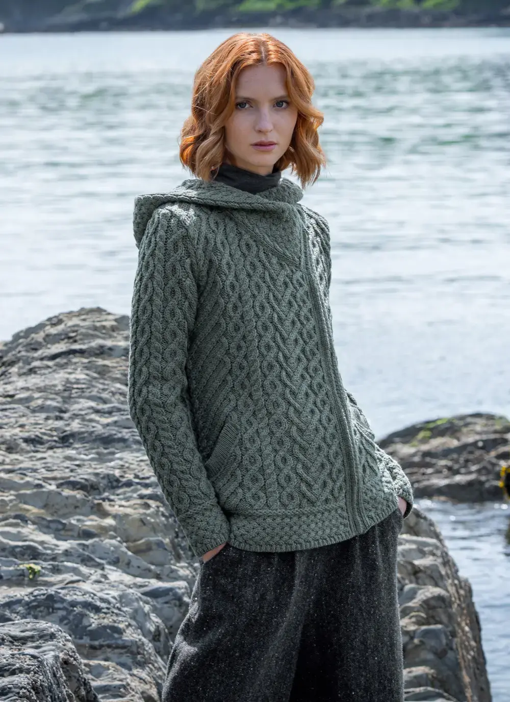 red head model at seaside in tundra aran cable knit biker hoodie