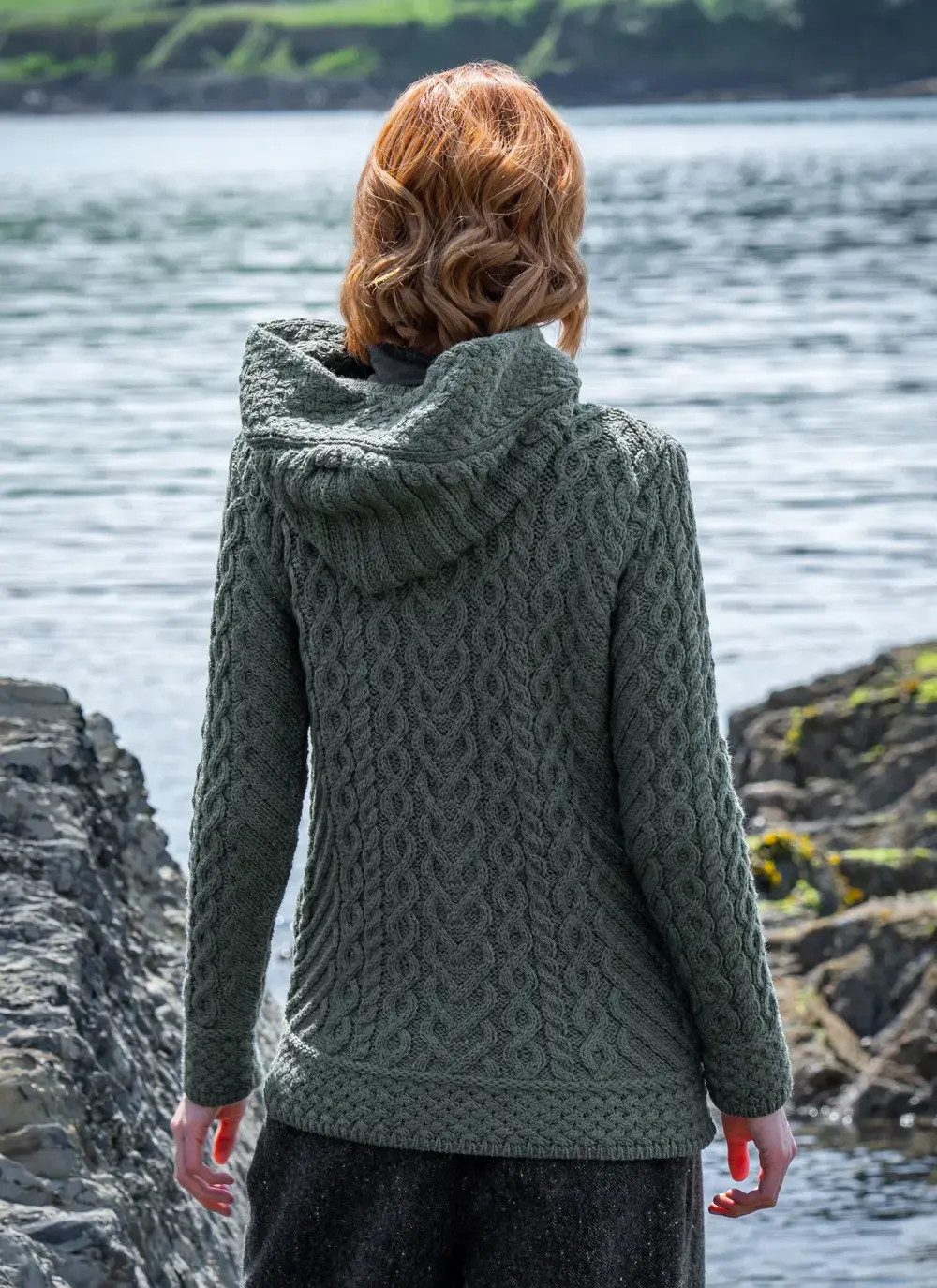 red head model at seaside in tundra aran cable knit biker hoodie back 