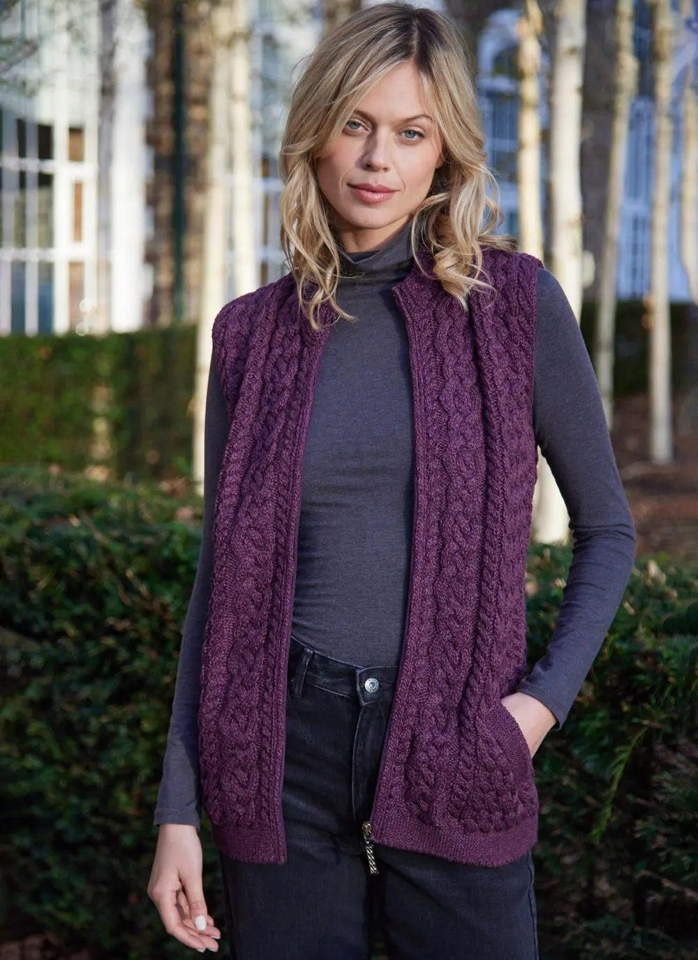 Women standing by trees wearing a purple aran gilet