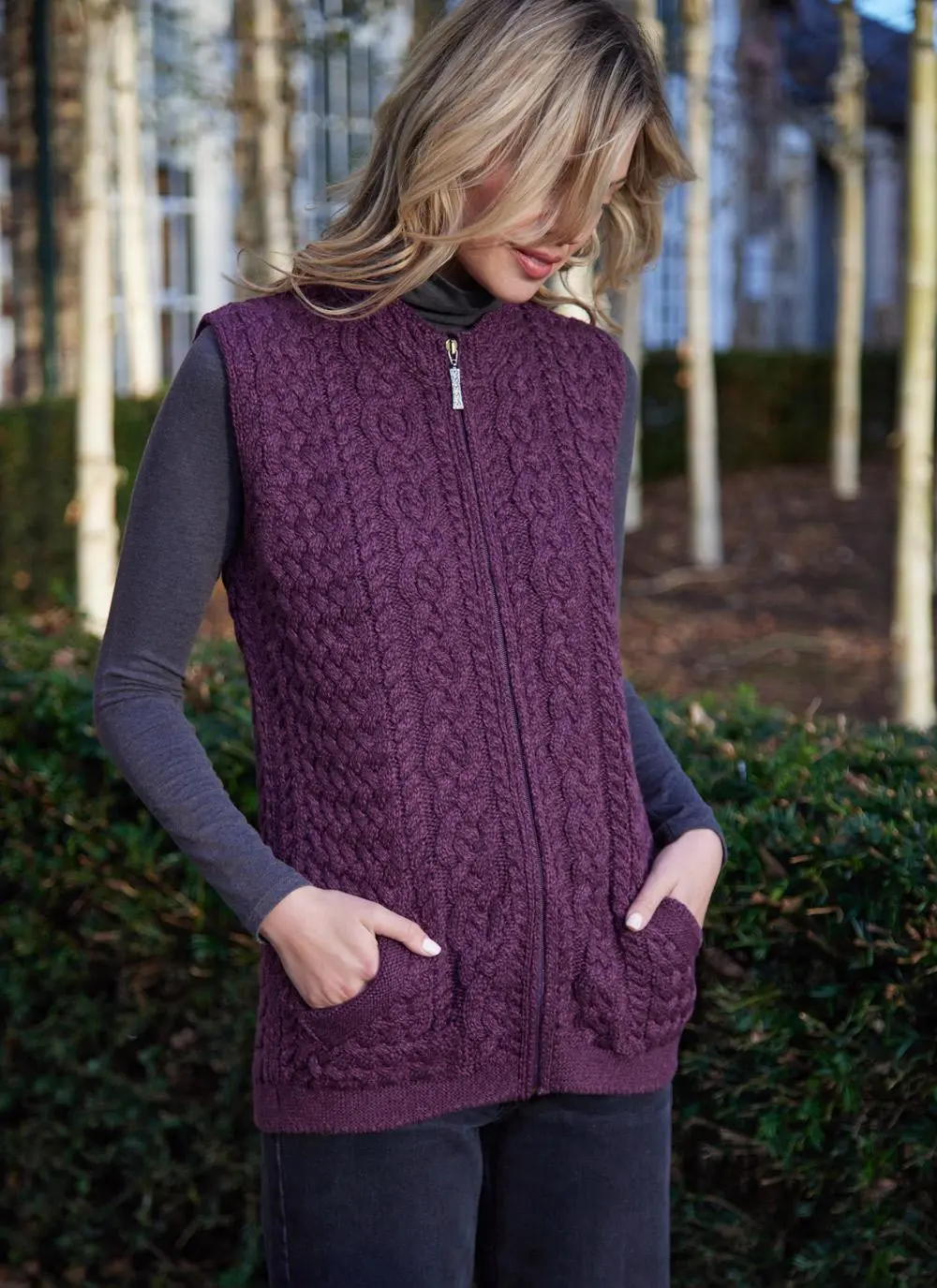 Women standing by trees wearing a purple aran gilet