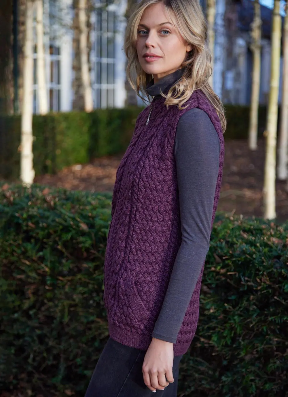 Women standing by trees wearing a purple aran gilet