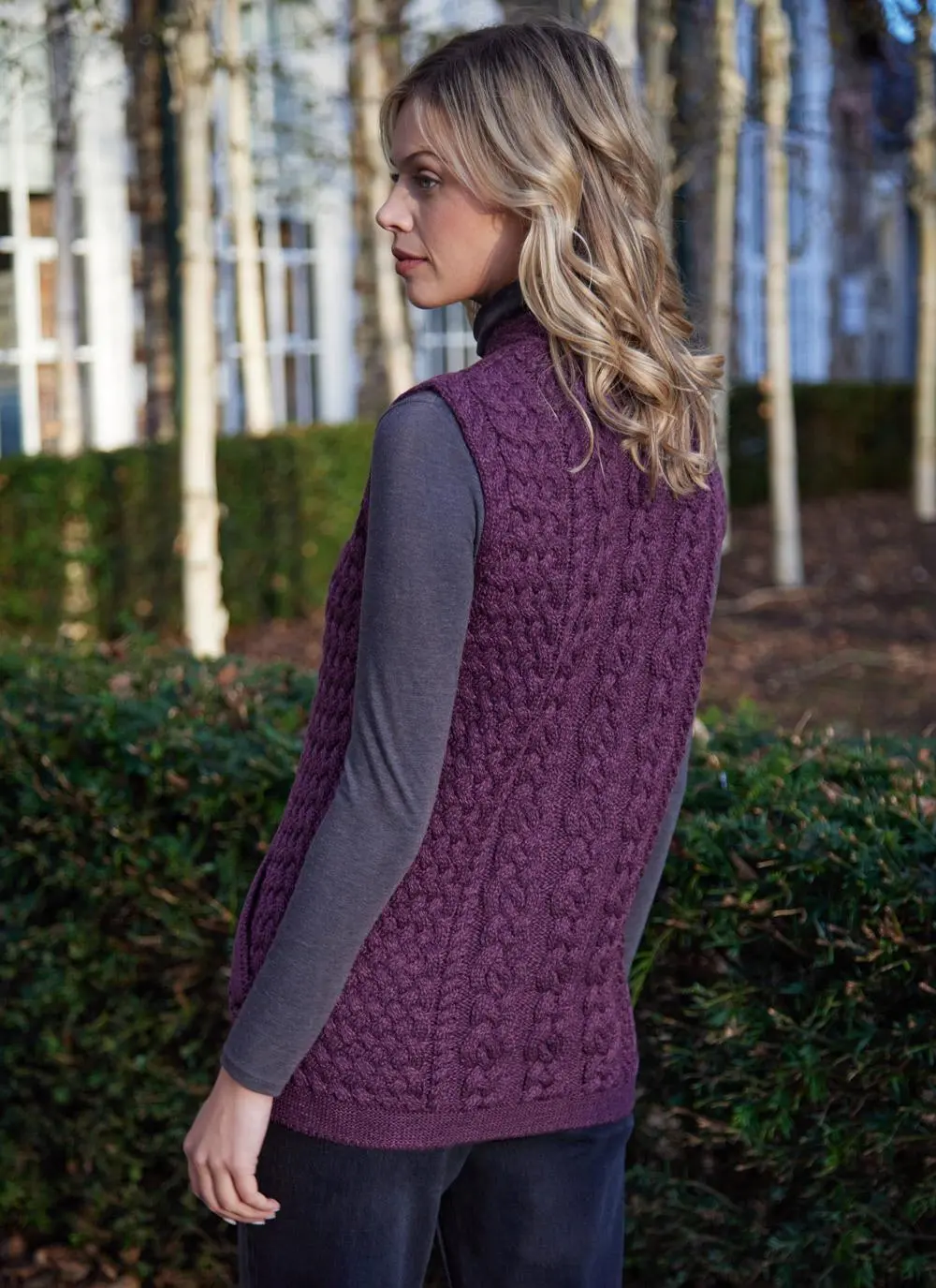 Women standing by trees wearing a purple aran gilet
