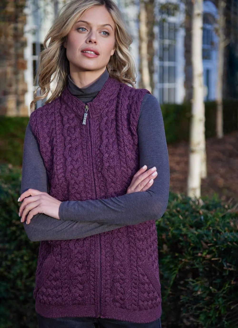 Women standing by trees wearing a purple aran gilet
