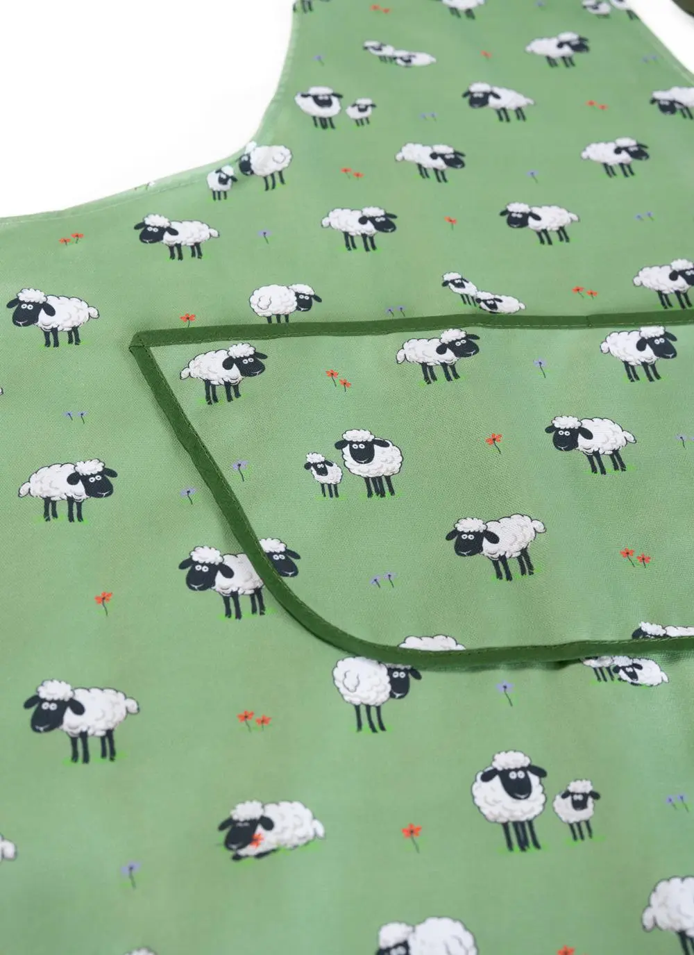 detail of green apron with sheep motif on white background