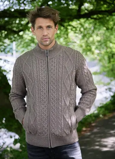 Man in the woods with a full zip aran cardigan on in brown marl