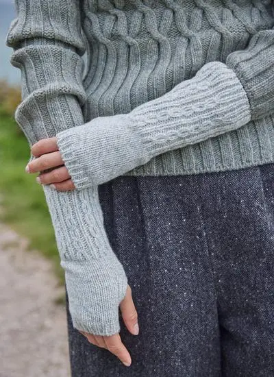 woman wearing cable knit grey hand warmers