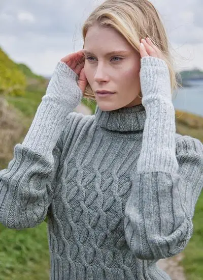 woman wearing cable knit grey hand warmers