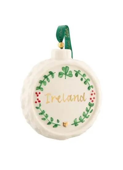 A round, ireland-themed christmas ornament featuring the word 