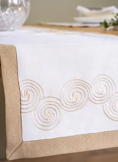 close up of table runner on table with celtic knots stitching