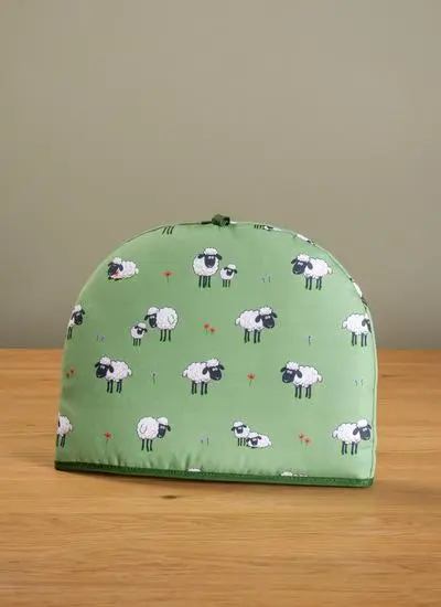 green tea cozy on table with green background