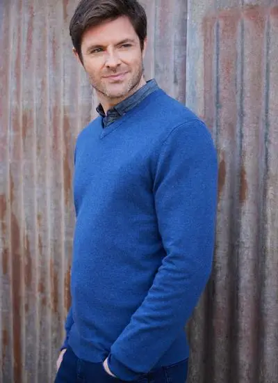 man wearing a blue lightweight lambswool v-neck sweater