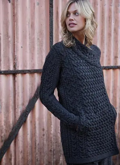Blonde woman wearing charcoal Aran cardigan with hand in pocket looking away